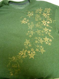 a green shirt with gold stars on it