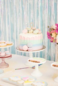 a table topped with cakes and desserts covered in frosting