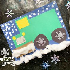 a paper plate with snowflakes on it and a green truck made out of construction paper