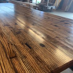 a wooden table top in a warehouse