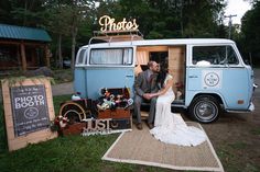 a bride and groom posing in front of an old vw camper at night