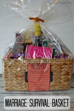 a basket filled with wine, chocolates and candy