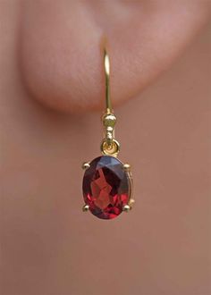 Our Garnet Dangle Earrings in gold vermeil are just the right size to be noticed and small enough to wear all day comfortably. The stone is a large 8mm natural deep red genuine Garnet popular as a January birthstone. Also available in sterling silver, see earrings section. Sold as a pair, comes with extra silicone ear backs to keep them secure. DETAILS * Dimensions: 8mm x 6mm, total length - 24mm * Material: 18k gold vermeil over 925 sterling silver base, genuine Garnet * Birthstone month - Janu Red Dangle Earrings, Gemstone Earrings Dangle, Garnet Birthstone, Drop Earrings Gold, Cut Earrings, Garnet Jewelry, January Birthstone, Garnet Earrings, Ear Rings