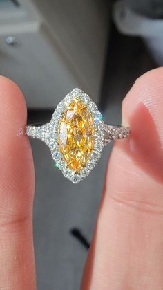 Beautiful Marquise Orange diamond set in a delicate Platinum ring with 0.62ct of rounds The diamond faces up predominantly orange Yellow Sapphire Diamond Ring With Gemstone, Fine Jewelry Cluster Topaz Ring With Diamonds, Cluster Diamond Ring With Gemstone, Yellow Diamond Ring With Gemstone, Yellow Diamond Rings With Gemstone, Formal Yellow Rings With Center Stone, Yellow Brilliant Cut Ring, Yellow Platinum Diamond Wedding Ring, Yellow Diamond Ring With Center Stone For Promise