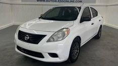 a white car is parked in a garage with the words auto sales written on it