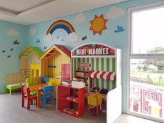 a child's playroom with colorful furniture and walls painted in blue, green, red, yellow and orange