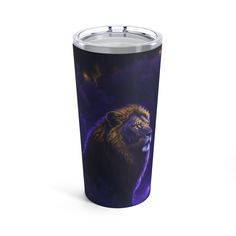 a travel mug with an image of a lion on the front and side, in purple hues