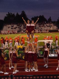 the cheerleaders are doing stunts for the team