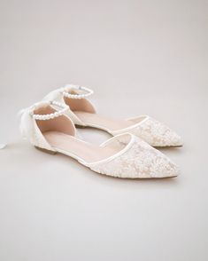 Crochet lace pointy toe flats for comfortable wear throughout your special day and perfect for wedding party. With pearl ankle strap to create a classic yet sophisticated look for any occasion. DETAILS: UPPER: Synthetic upper and lining MATERIALS: Manmade outsole HEEL HEIGHT: 0.3" ORIGIN: Imported Elegant Bridesmaid Pointed Toe Flats, Elegant Cream Low Heel Flats, Chic Low Heel Ballet Flats For Wedding, Chic Closed Toe Ballet Flats For Wedding, Elegant Ankle Strap Ballet Flats, Chic Ballet Flats For Wedding In Spring, Elegant Cream Flats For Party, Chic Ballet Flats For Spring Weddings, Chic Wedding Ballet Flats