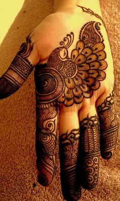 a hand with henna tattoos on it