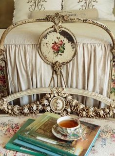 an old fashioned bed with flowers on the headboard