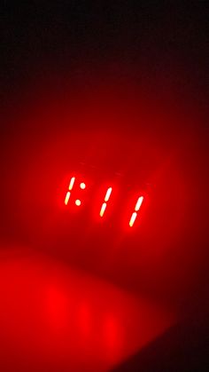 a red digital clock sitting on top of a table