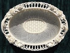 a white doily bowl with roses on it