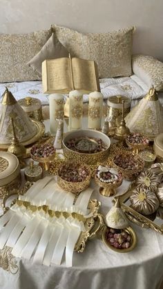 a table topped with lots of gold and white items