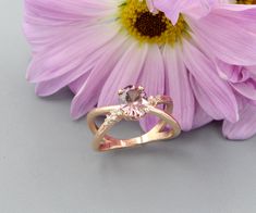 Most people have seen a blue zircon, but have never seen a natural rose zircon! This unique colored gemstone displays a beautiful pink color and complements the rose gold setting. Notice the designer-cut on this not-so-quite oval shape zircon. DETAILS 1.90-carat Genuine Zircon (8x6mm) .07cttw round brilliant cut diamonds Material: 10k Rose Gold Oval Pink Sapphire Rose Gold Jewelry, Oval Rose Gold Pink Sapphire Jewelry, Rose Gold Oval Pink Sapphire Jewelry, Rose Gold Oval Morganite Topaz Ring, Oval Rose Gold Topaz Promise Ring, Rose Gold Oval Topaz Promise Ring, Diamond Gold Ring, Diamond Gold, Blue Zircon