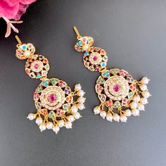 Featuring a jadau necklace with matched pair of long earrings in 22k Gold. The set is studded with navratan color stones. The necklace weighs 22.0 gms including 0.89 gms in the hanging pearl beads. The earrings weigh 14.53 gms including 1.79 gms in the hanging pearl beads. Price Breakup Summary Component Rupees % of Total 22k Gold 173,447 77.0% Stones & Beads 14,040 6.2% Making Charges 31,220 13.9% Taxes (GST) 6,561 2.9% Total 225,268 100.0% View Detailed Price Breakup Navratna Necklace, 22k Gold Jewelry Necklaces, Jadau Necklace, Indian Gold Jewelry, 22k Gold Jewelry, Pearl Necklace Set, Color Stones, Gold Jewelry Necklace, Emerald Necklace