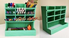 two green containers with pens, pencils and markers