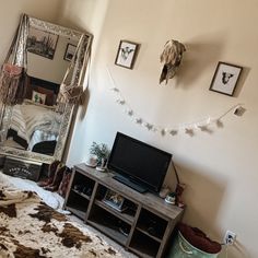 a bedroom with a cow hide rug and mirror