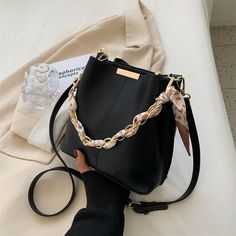 The Audrey Bucket Bag is a minimalist bag with a unique twist!Made from our Premium Vegan Leather, it comes in a structured design with a smooth finish. Features a matching scarf for extra styling options. It opens up to an extra spacious interior and a zippered pocket that will definitely fit your everyday essentials. Minimalist Bag, Structured Design, Black Hand, Everyday Essentials, Leather Top, Casual Outfit, Timeless Pieces, Soft Leather, Bucket Bag