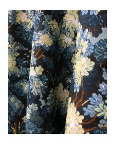 an image of a blue and yellow flowered curtain with white flowers on the side