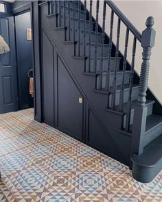 the stairs are painted blue and brown with geometric designs on them in this entryway