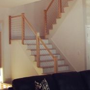 a living room filled with furniture and a stair case