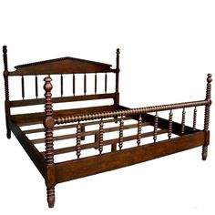 an old wooden bed frame with wood posts and spindles on the headboard, against a white background