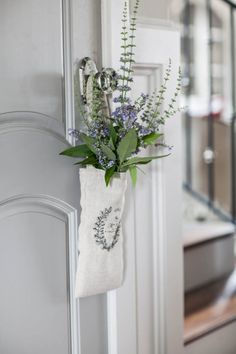 a white door with a plant hanging from it's side