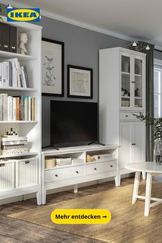 a white entertainment center with bookshelves and shelves