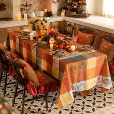 a dining room table set with place settings