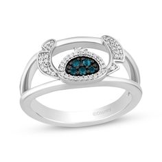 a white gold ring with blue and white diamonds in the center, set on top of an