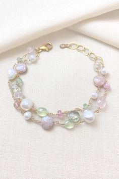 This luxe layered bracelet boasts a lavish combination of pink and green gemstones and freshwater pearls, creating a refined and feminine design. Lobster clasp and extender chain allow for an adjustable fit. Bracelet length:  7.5-8.5 inches Materials:  gold fill, rose quartz, prehnite, tourmaline, mystic moonstone, green amethyst, cultured freshwater pearls GIFTING ~ Jewelry gift box included. ~ I am happy to ship directly to the recipient.  Enter their address during checkout. ~ If you would like a gift note included in the package, please leave the text of the note in the "Add a note to Marsh Creek Jewelry" message box at checkout. FREE SHIPPING ~ Orders ship within 2 business days. ~ Free shipping is First Class ~ Priority Mail and Express Shipping upgrades are available during checkout Luxury Gemstone Chain Bracelet For Gift, Luxury Gemstone Chain Bracelet As Gift, Luxury Faceted Bracelets For Gift, Luxury Gemstone Beaded Bracelets For Weddings, Rose Quartz And Labradorite Bracelet, Elegant Pearl Beaded Bracelets With Gemstones, Elegant Green Pearl Bracelet With Natural Stones, Elegant Multi-strand Gemstone Beaded Bracelets, Elegant Multi-strand Bracelet With Faceted Beads