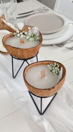 two trays with flowers on them sitting on a dining room table set for dinner