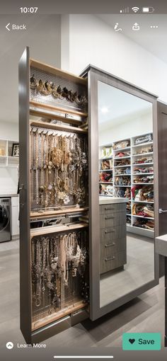 an open closet with lots of jewelry inside of it and a washer dryer in the background