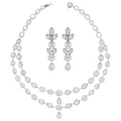 The Tara Necklace & Earrings Suite features a elegant timeless design that highlights each diamond and impresses with its simple yet stated style. Its bold earrings bring attention Diamonds Shapes: Pear Shape, Oval, Marquise & Round Total Diamonds Weight: 24.74 ct (Necklace) & 6.59 ct (Earrings) Diamonds Color: F - H Diamonds Clarity: SI (Slightly Included) Metal: 18K White Gold Metal Wt: 53 gms (Necklace) & 20.55 gms (Earrings) Setting: Prong Set Length: 15.5 Inches & 2.6 Inches Price Quoted ma Diamonds Shapes, Dna Earrings, Pearl Chandelier Earrings, Diamond Chandelier Earrings, Noble Lady, Stones Necklace, Earrings Chandelier, Aesthetic Edits, Bold Earrings