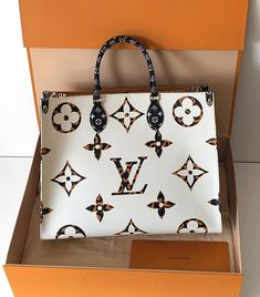 In Monogram Jungle canvas, this Louis Vuitton Onthego is Ivory on one side and Havana Beige on the other, with animal print sides. Louis Vuitton Onthego, Michael Kors Hamilton, Havana, Tap, Animal Print, Top Handle Bag