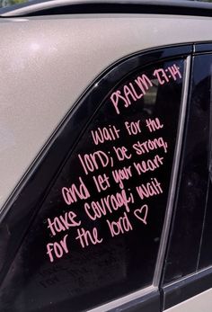 a car with pink writing on the windshield