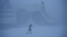 a person running through the snow in front of a building