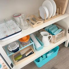 dishes and utensils are organized on the shelf