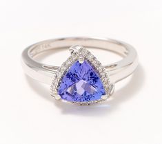 Gemstones and diamonds are an exquisite combination that will always be en vogue. This 14K white gold ring showcases both with such timeless beauty that you won't want to remove it from your finger. From Affinity® Fine Jewelry. Tanzanite And Diamond Ring, Tanzanite Diamond Ring, Diamond Halo Ring, Tanzanite Diamond, Tanzanite Gemstone, Deco Vintage, 14k White Gold Ring, 14k Gold Ring, White Gold Ring