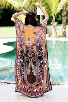 Want to shop for a dress that is comfortable, classy and elegant at the same time? Then this alluring Silk Kaftan dress with glittering crystal work is the best choice for you. The minimal V neckline sets a perfect combination with sassy sidelines of the silk Kaftan dress. The beauty of brown shade is more evident with tinge of orange, maroon, black and white. Swim wear kaftan Style it with white earrings and white heels for a relaxing day at beach. ONE SIZE FIT ALL KAFTAN ( Small to 8XL) Materi Bohemian Maxi Dress With Dabka, Bohemian Tunic Dress With Dabka Detailing, Summer Maxi Dress With Dabka Detail, Summer Maxi Length Dress With Dabka Detailing, Summer Maxi Dress With Dabka Embroidery, Bollywood Style V-neck Beach Dress, Bollywood Style Dabka Summer Dresses, Bollywood Style Dabka Dress For Summer, Bollywood Dabka Dresses For Summer