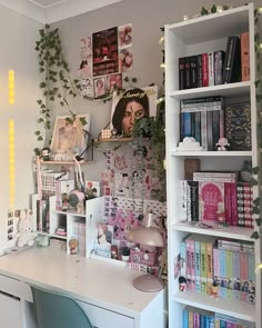 there is a desk with books on it and plants growing up the wall behind it