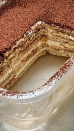 there is a cake that has been cut in half with chocolate and powdered sugar on top