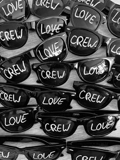 many pairs of sunglasses with the words love, love, and creu written on them