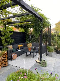 an outdoor living area with couches, tables and potted plants