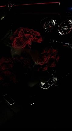 the interior of a car with red roses on the dash board and steering wheel controls