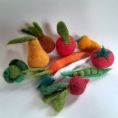 there are several felt fruits and vegetables on the table