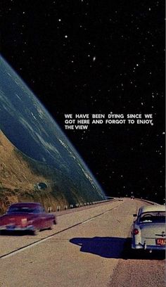 two cars are driving down the road in front of an earth - like object with a quote on it