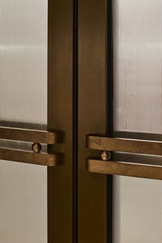 two glass doors with metal handles on each side