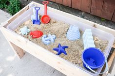 a sandbox filled with different types of toys